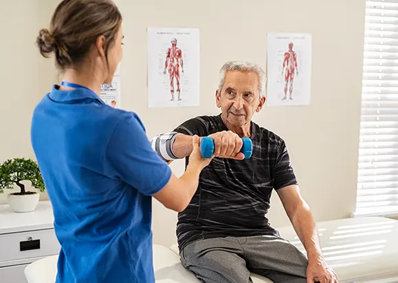 A physical therapist checking her patient's condition